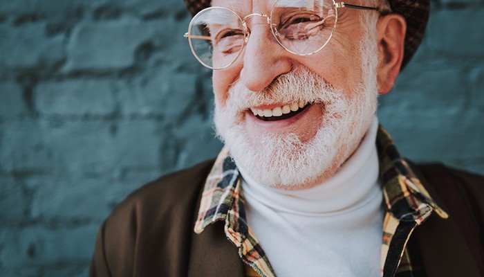 Close-up of a senior man with glasses smiling