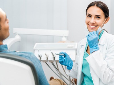 Dentist smiling at patient's dental exam