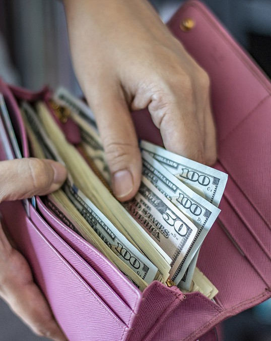 Woman with a wallet of cash