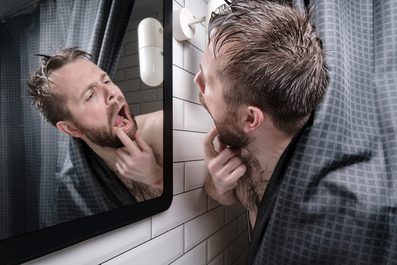 Patient checking their gums for gingivitis